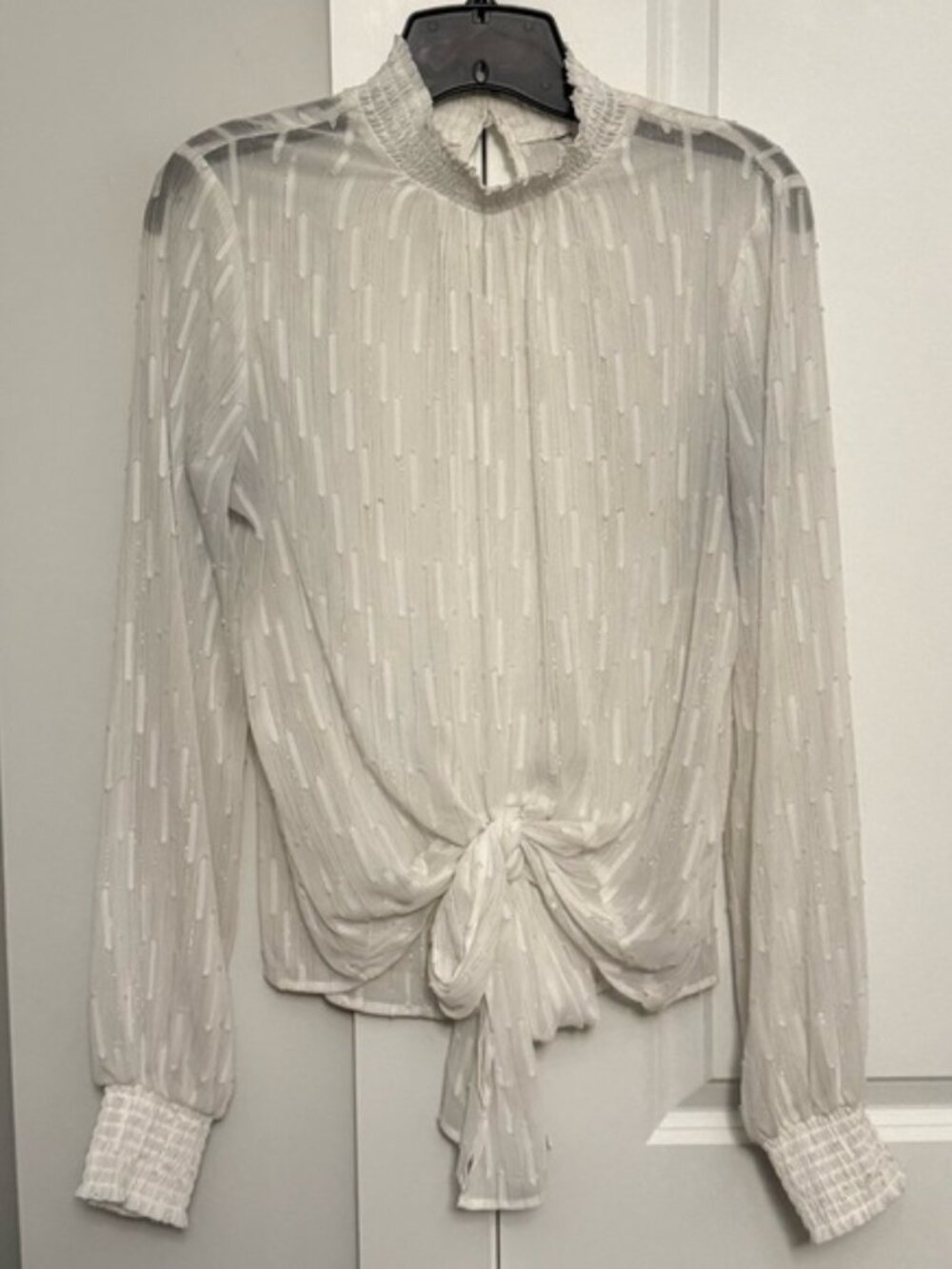 White and silver sheer Express blouse. Has a large tie on the front. Size small.
